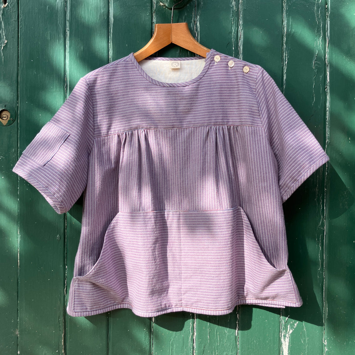 striped smock top with side buttons and three pockets