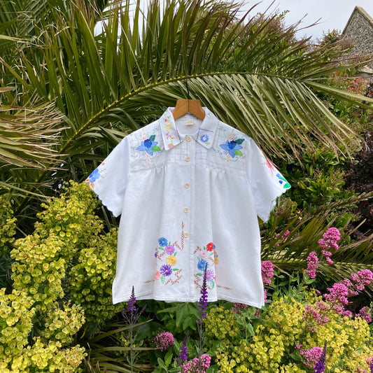 patchwork recycled tablecloth shirt hanging among some summer flowers