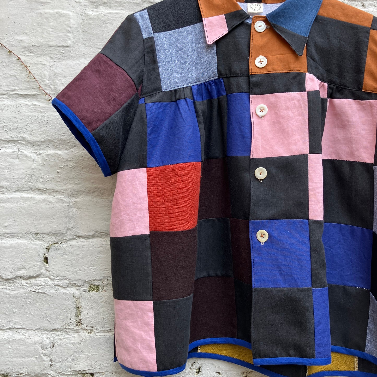 Shirt made from a patchwork of cotton and linen offcuts in black and muted brights.