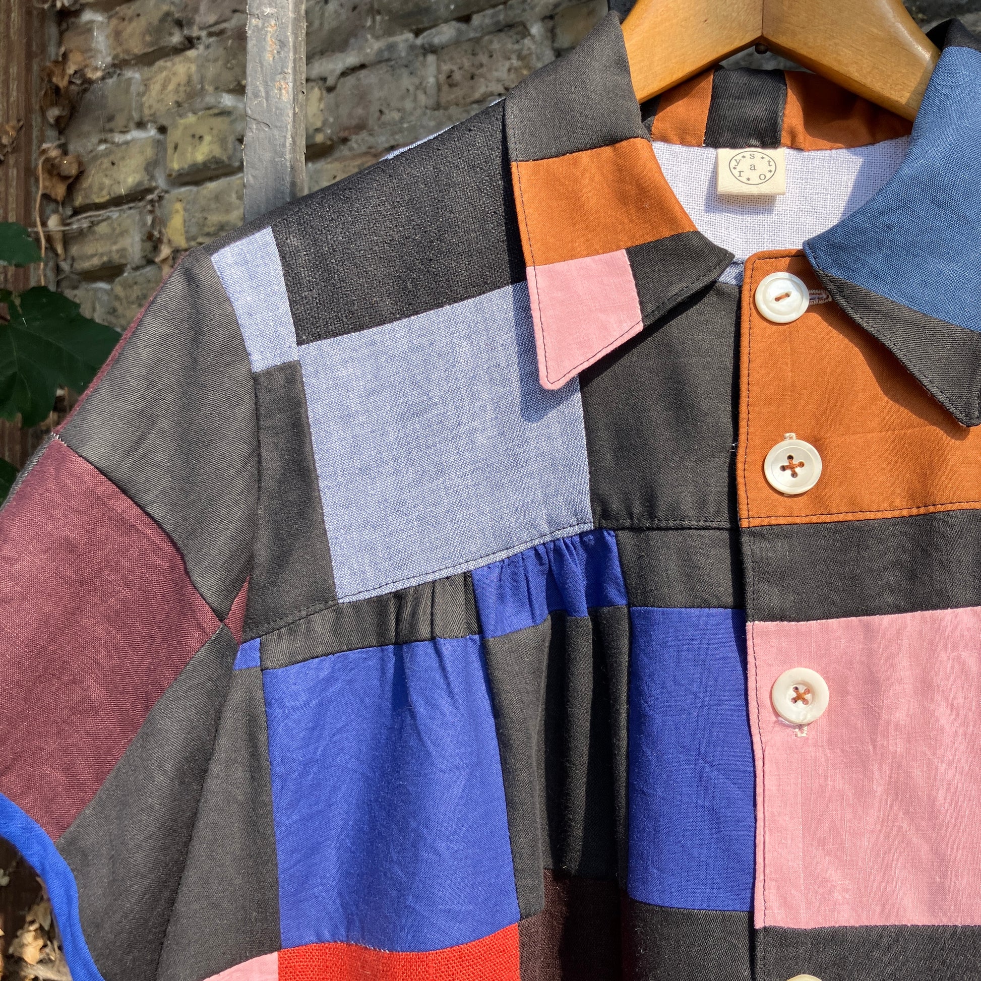 Shirt made from a patchwork of cotton and linen offcuts in black and muted brights.