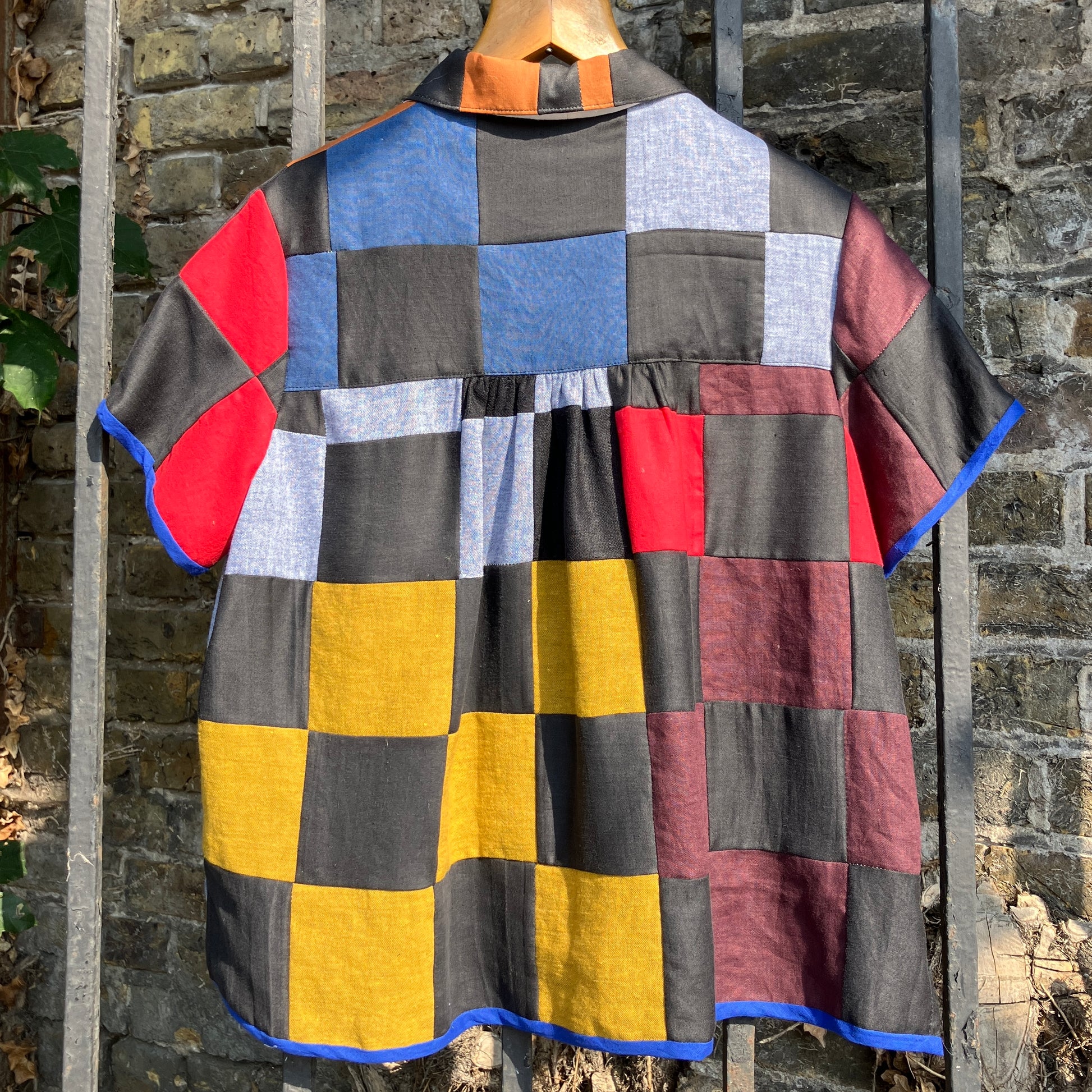 Shirt made from a patchwork of cotton and linen offcuts in black and muted brights.