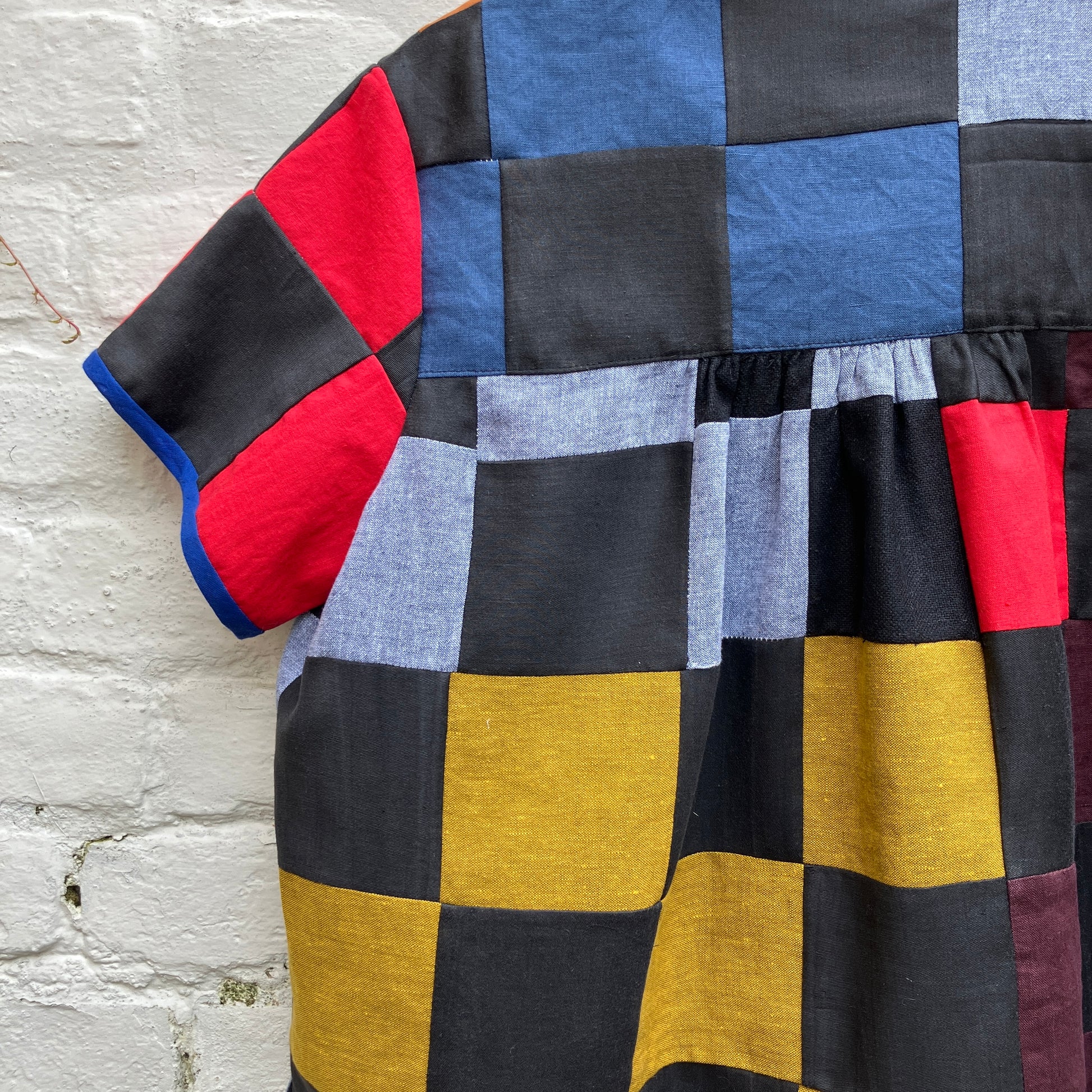 Shirt made from a patchwork of cotton and linen offcuts in black and muted brights.