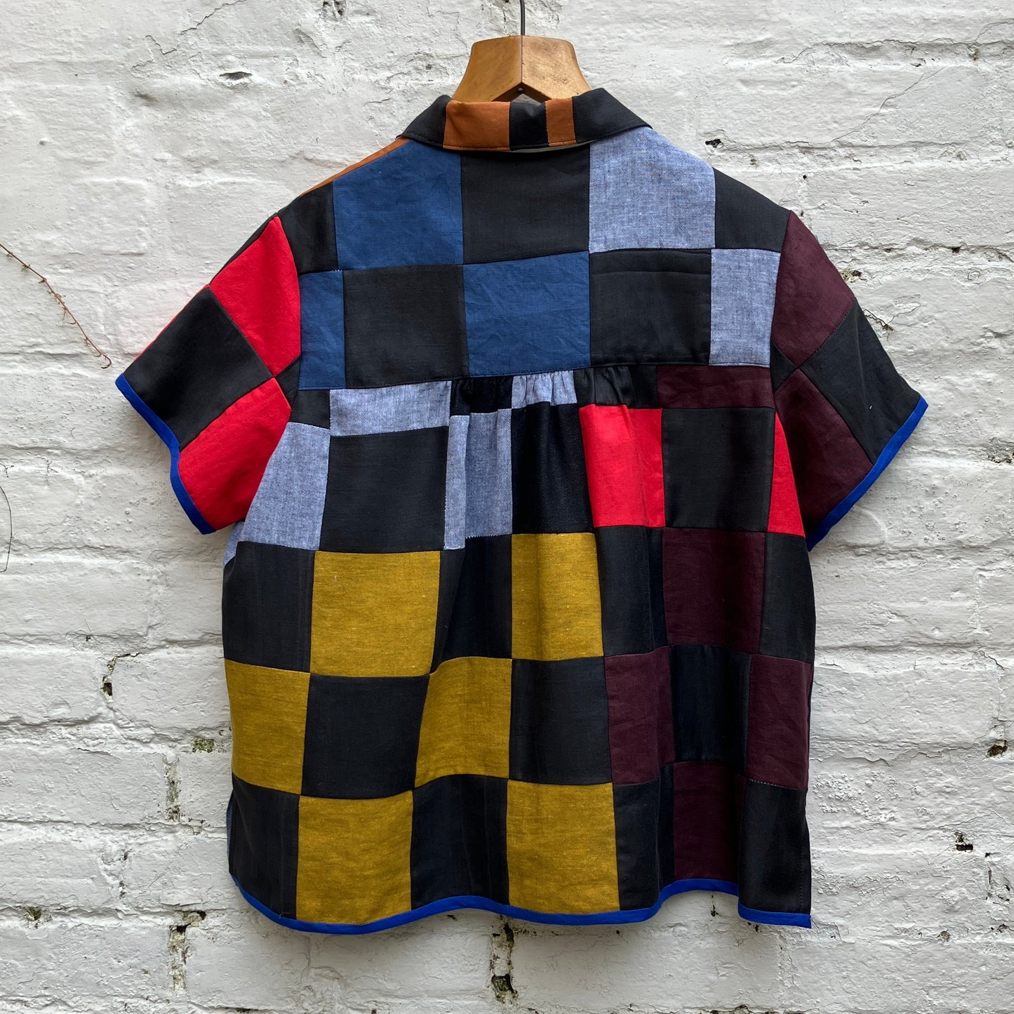 Shirt made from a patchwork of cotton and linen offcuts in black and muted brights.