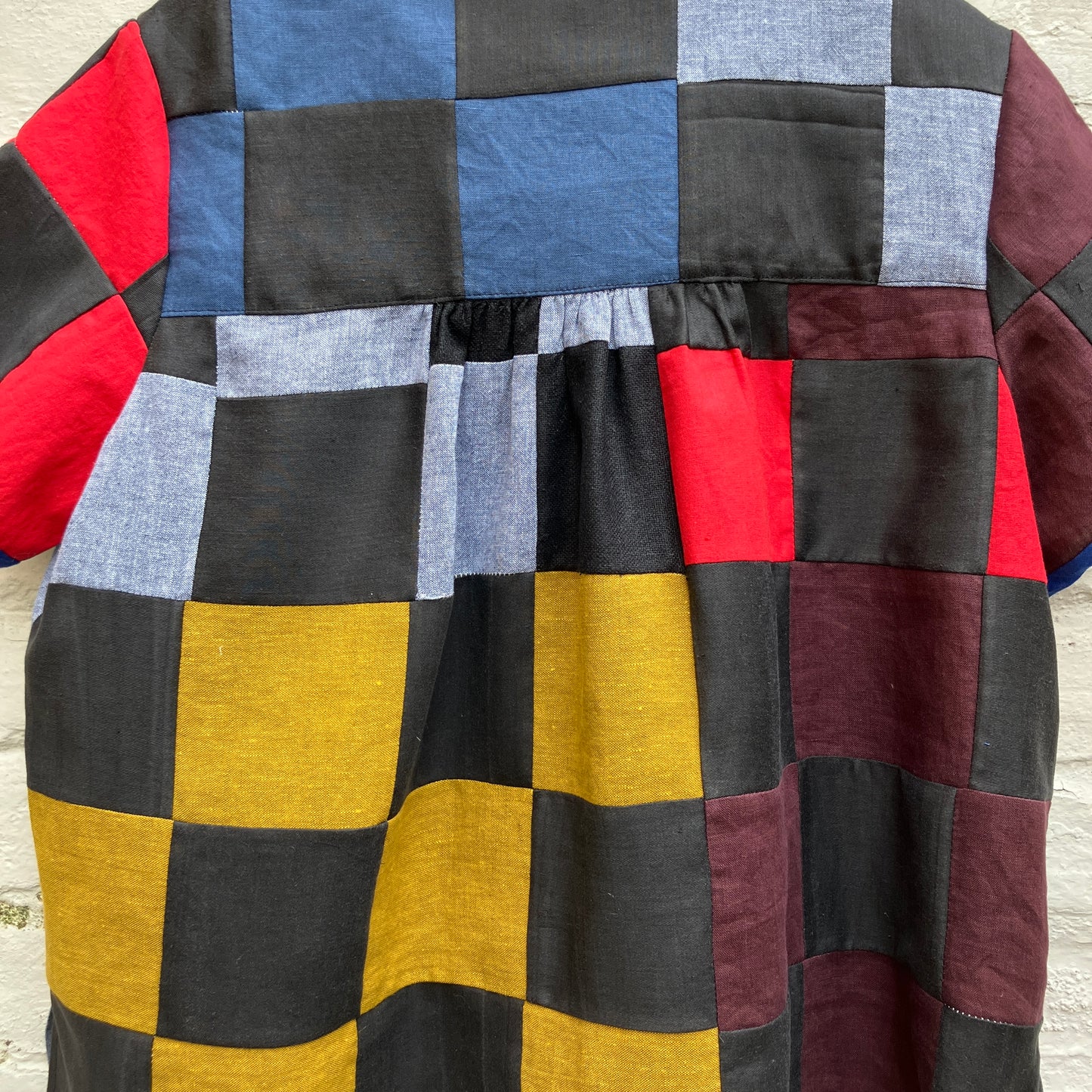 Shirt made from a patchwork of cotton and linen offcuts in black and muted brights.