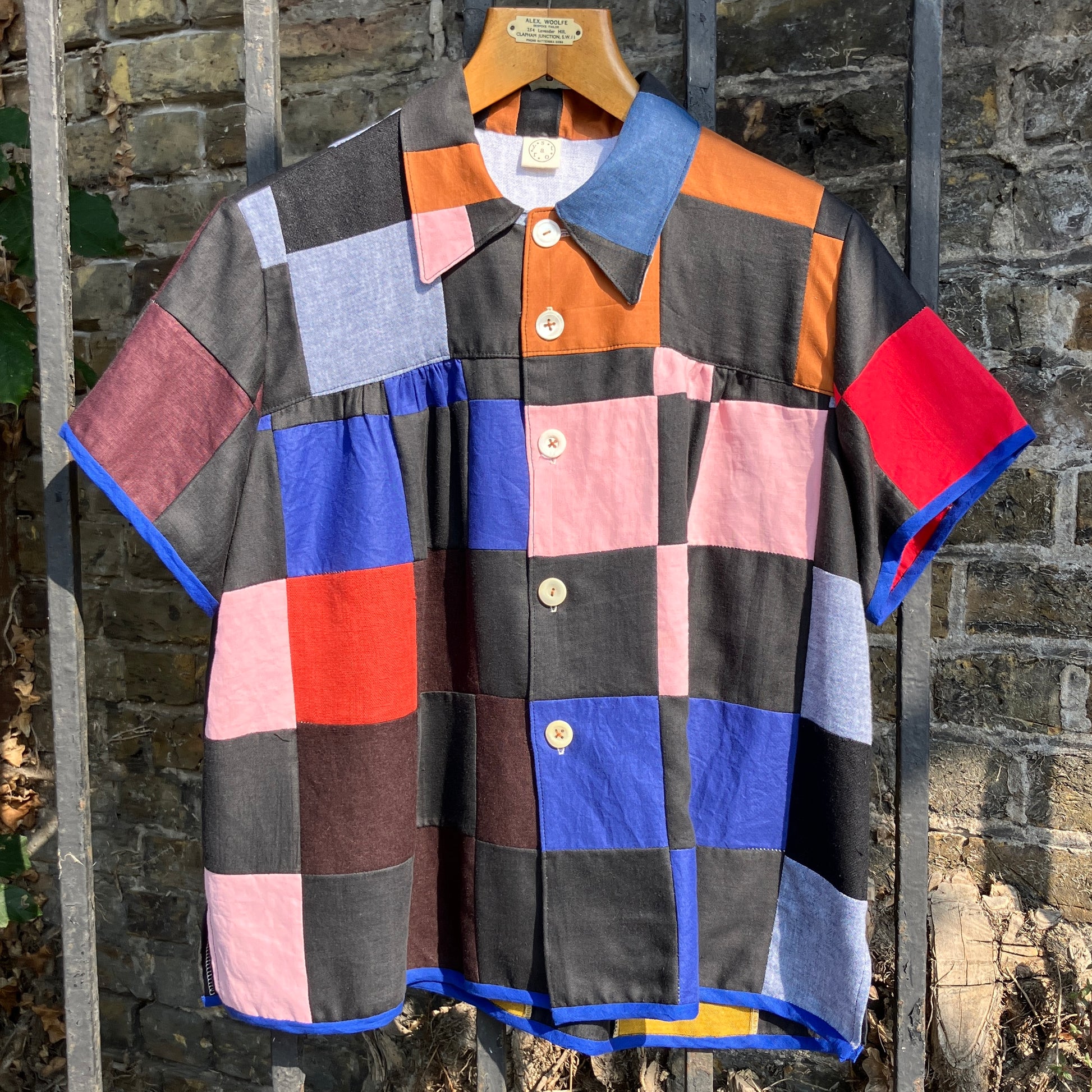 Shirt made from a patchwork of cotton and linen offcuts in black and muted brights.