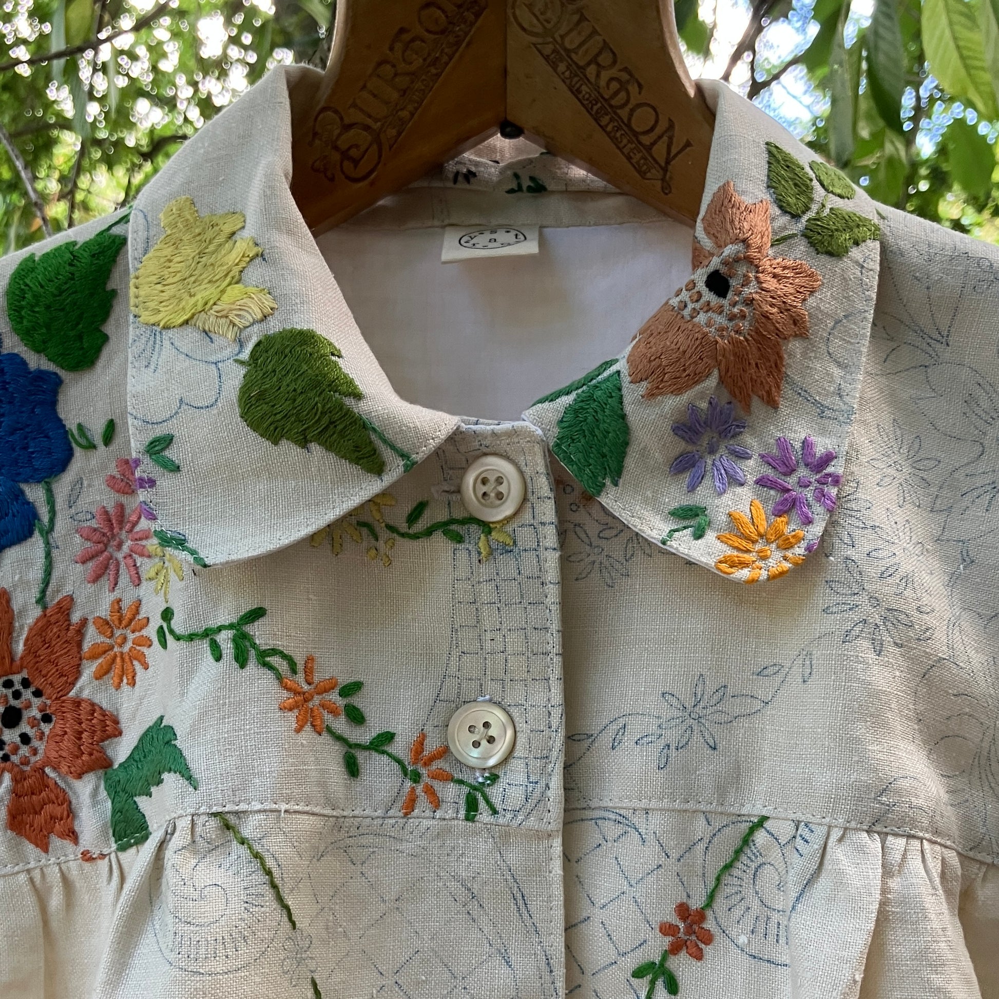 Blouse made from a recycled part-embroidered vintage linen tablecloth