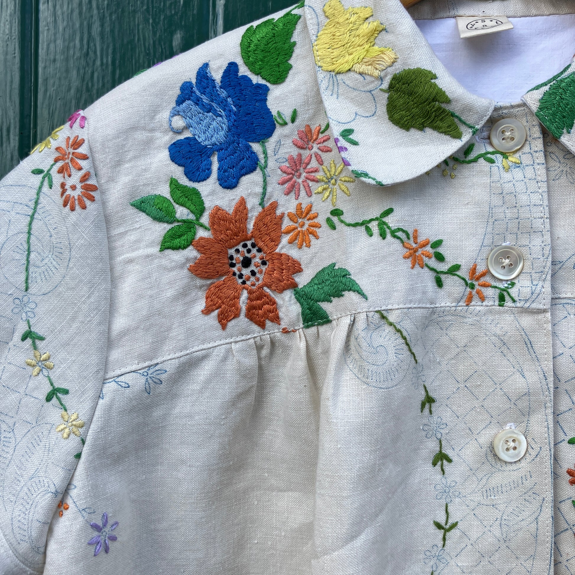 Blouse made from a recycled part-embroidered vintage linen tablecloth