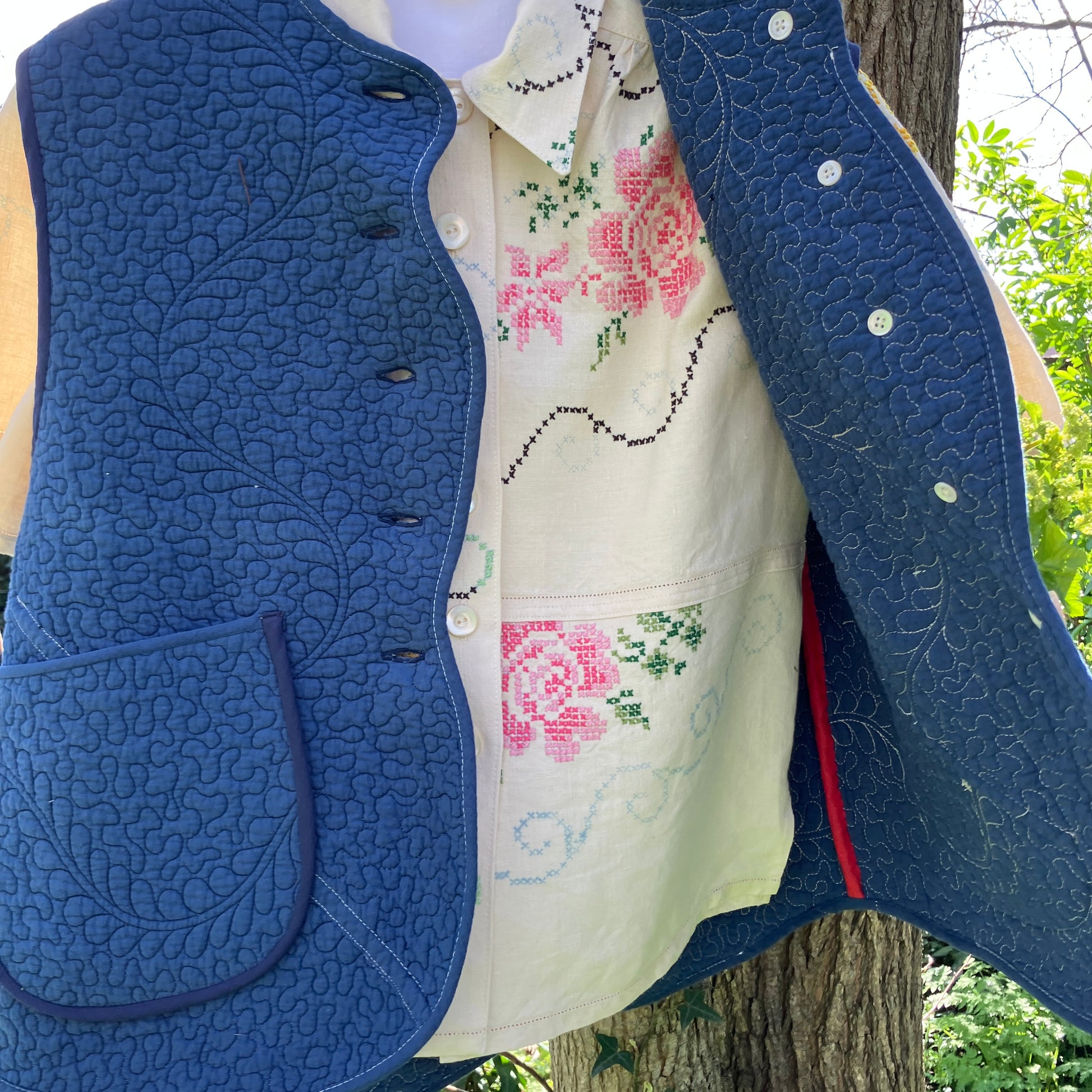 blue vest made from a recycled quilt worn with a recycled tablecloth blouse