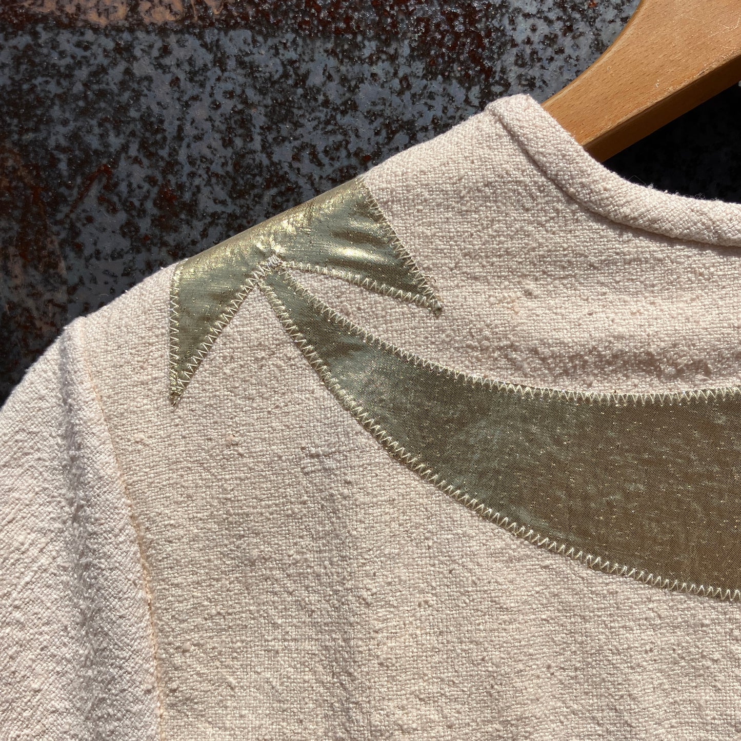 neutral-coloured raw silk smock with gold weather-themed appliqué