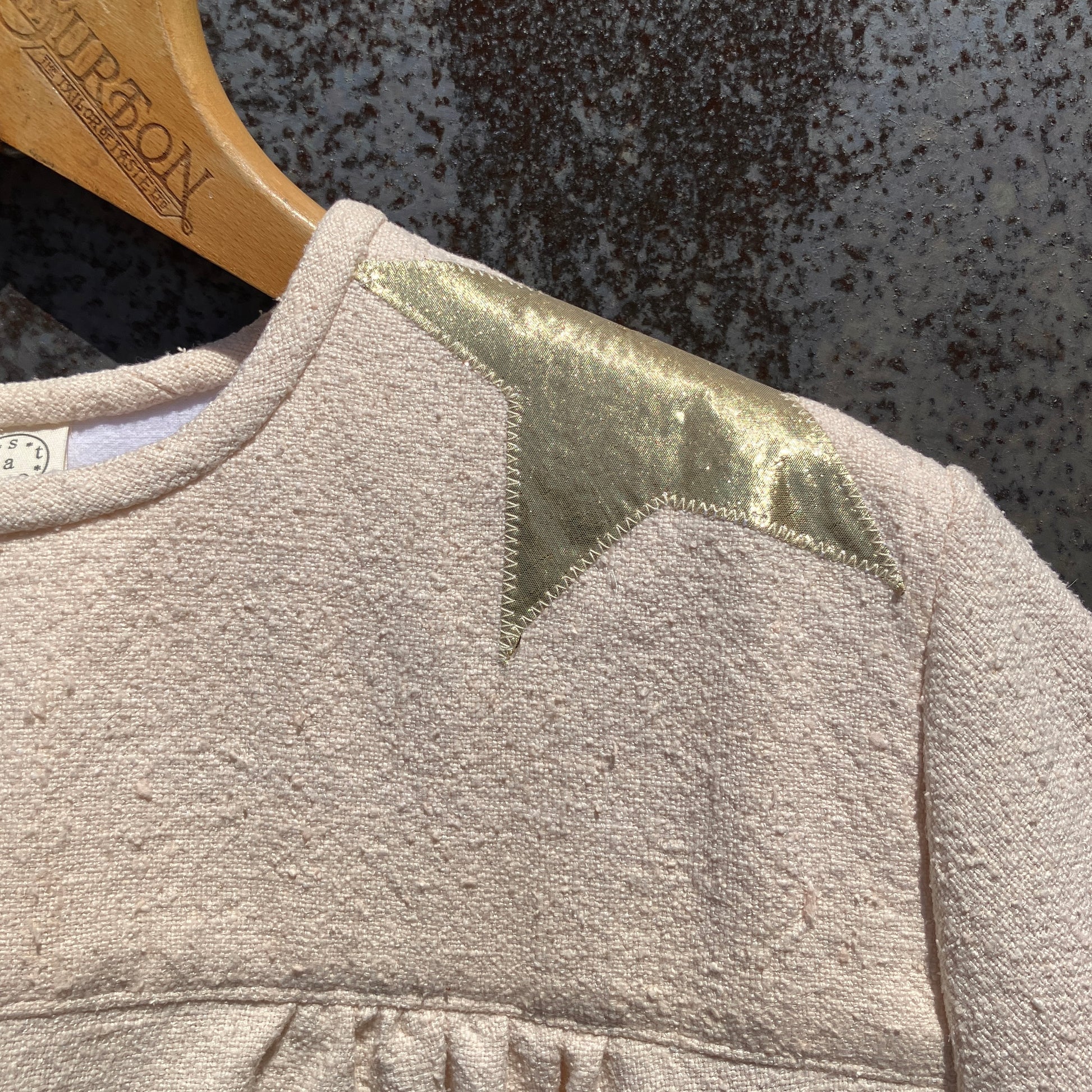 neutral-coloured raw silk smock with gold weather-themed appliqué