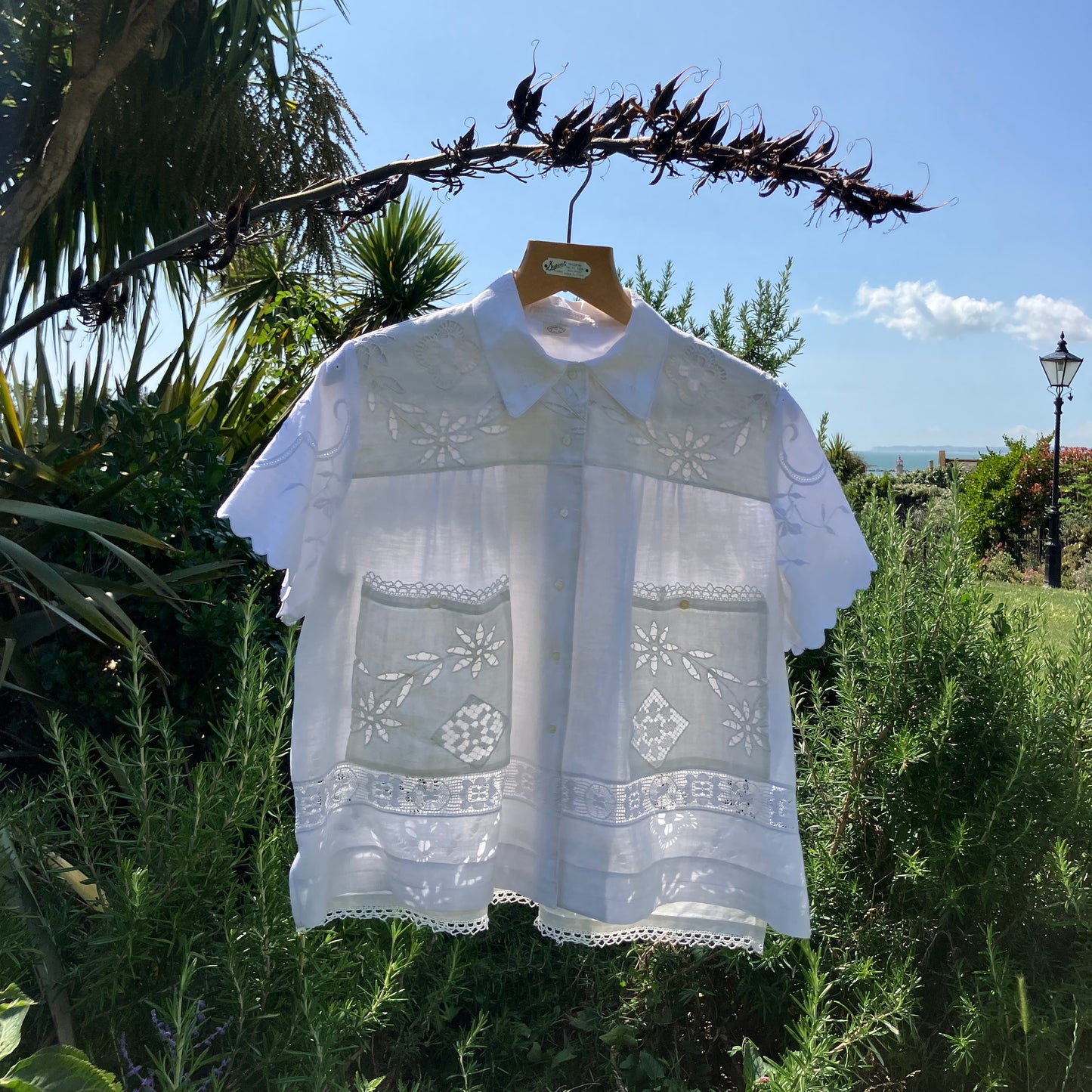 Short-sleeved white swingy shirt made from vintage cutwork linen and cotton cutwork table and tray cloths.