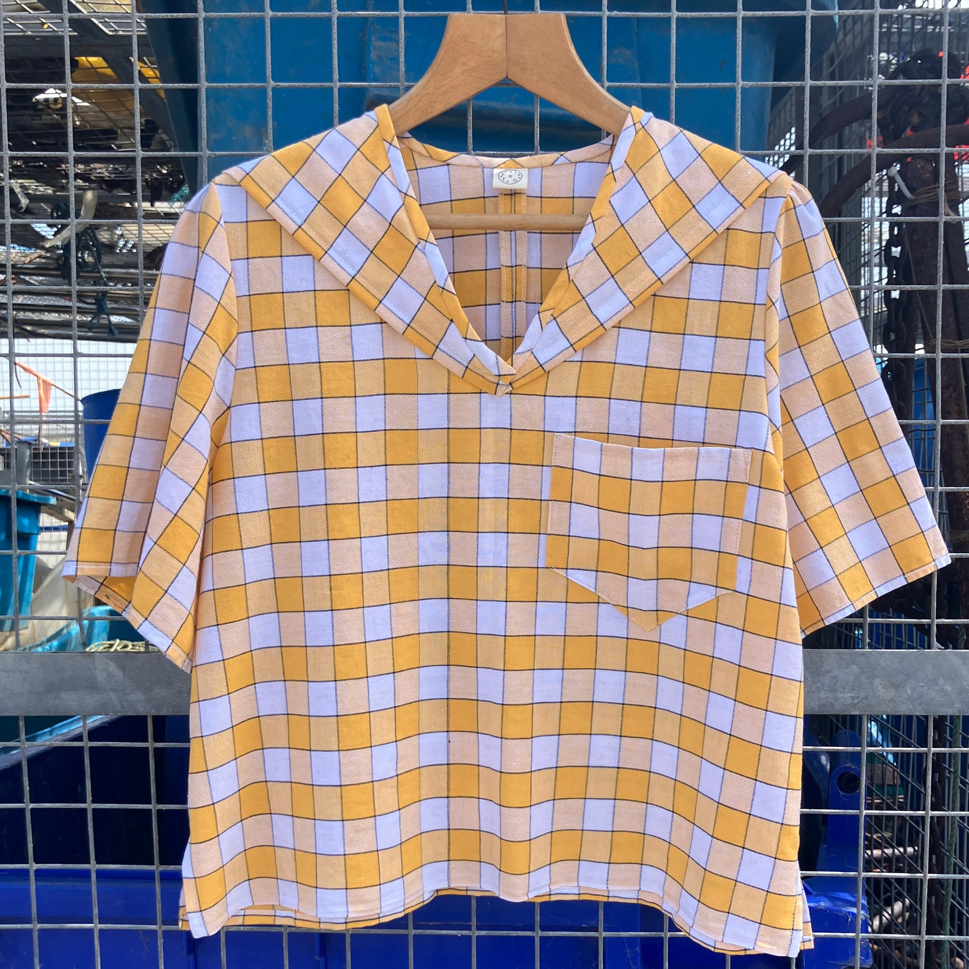 Short sleeved sailor-collar top made from a reclaimed yellow and white checked vintage tablecloth