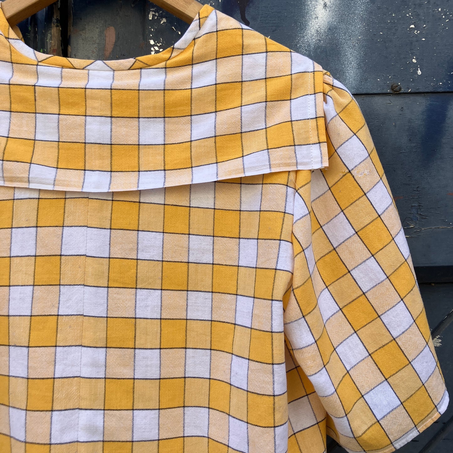 Short sleeved sailor-collar top made from a reclaimed yellow and white checked vintage tablecloth