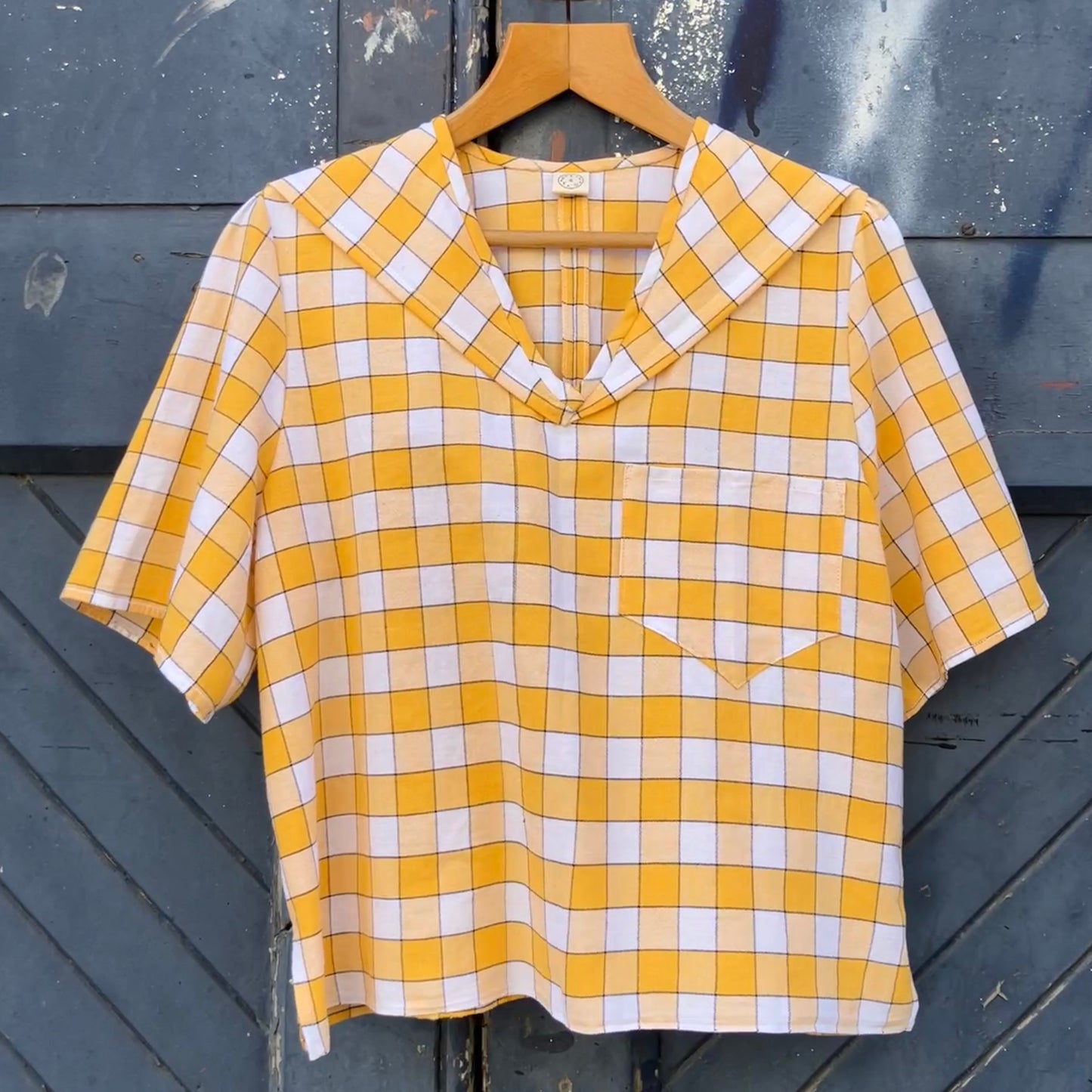 Short sleeved sailor-collar top made from a reclaimed yellow and white checked vintage tablecloth