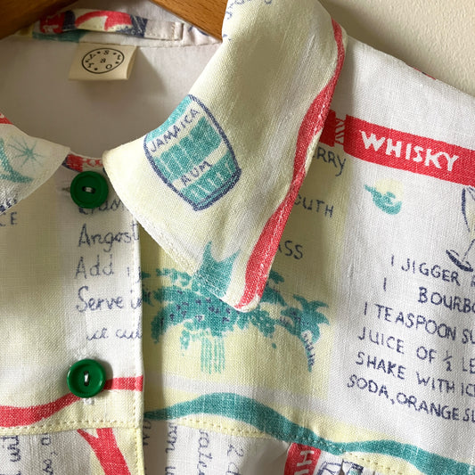 A shirt handmade from a vintage 'cocktails' tablecloth, featuring recipes and illustrations (close-up of collar)